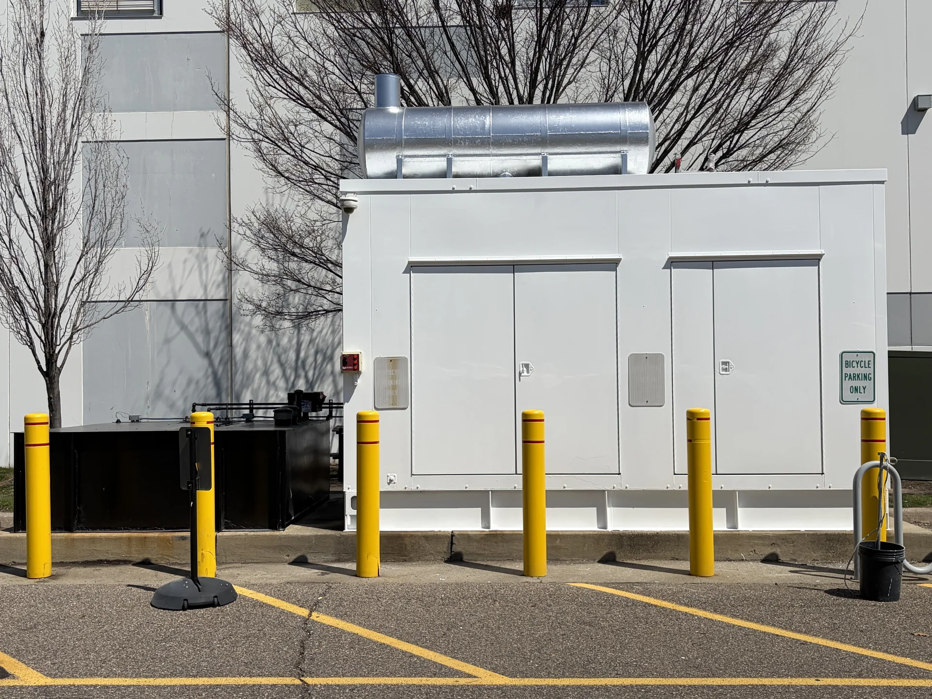 Backup generator enclosure and freshly painted fuel tanks after cleaning and repaint