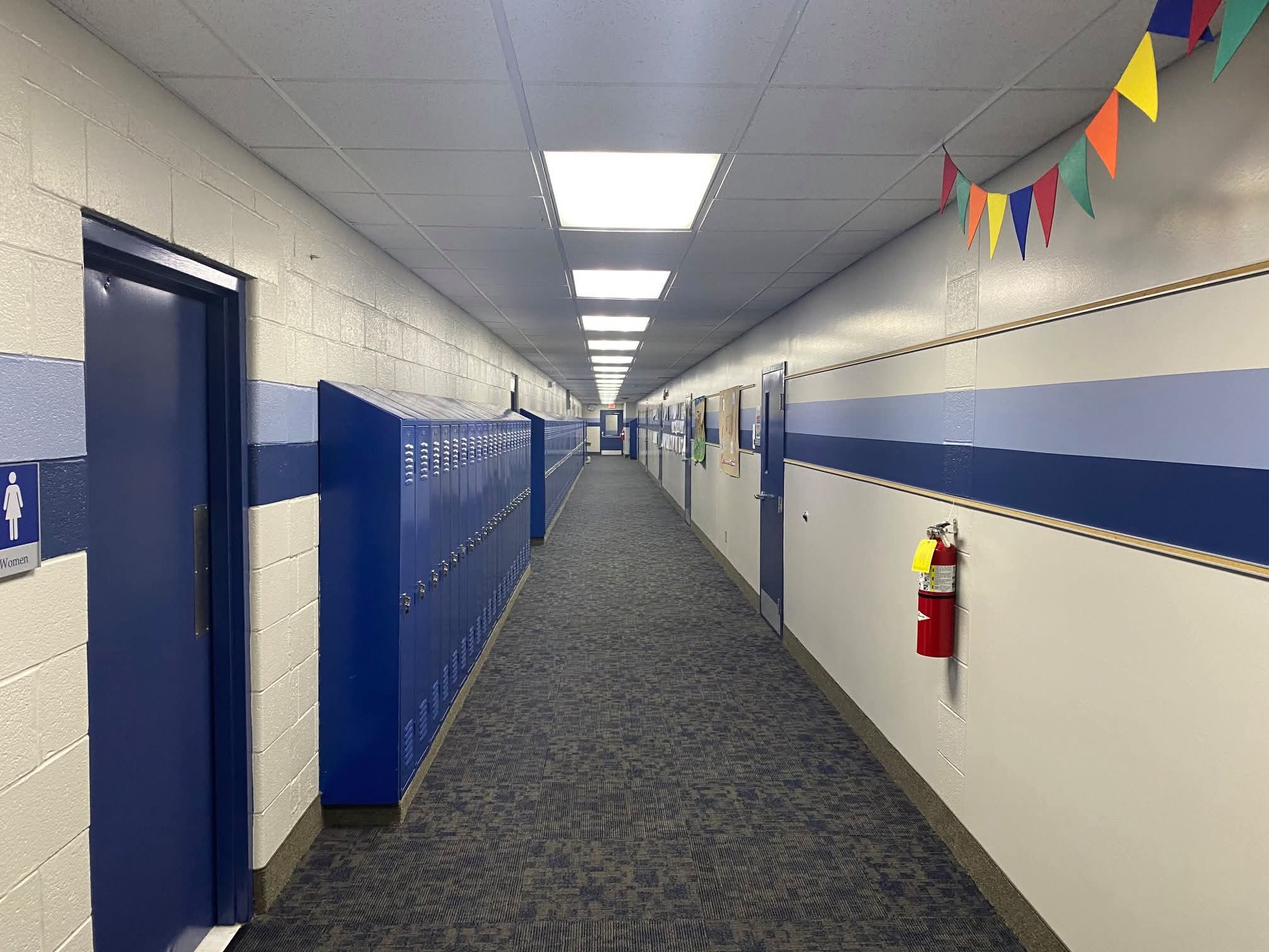 Finished school hallway — blue and white with matching blue lockers