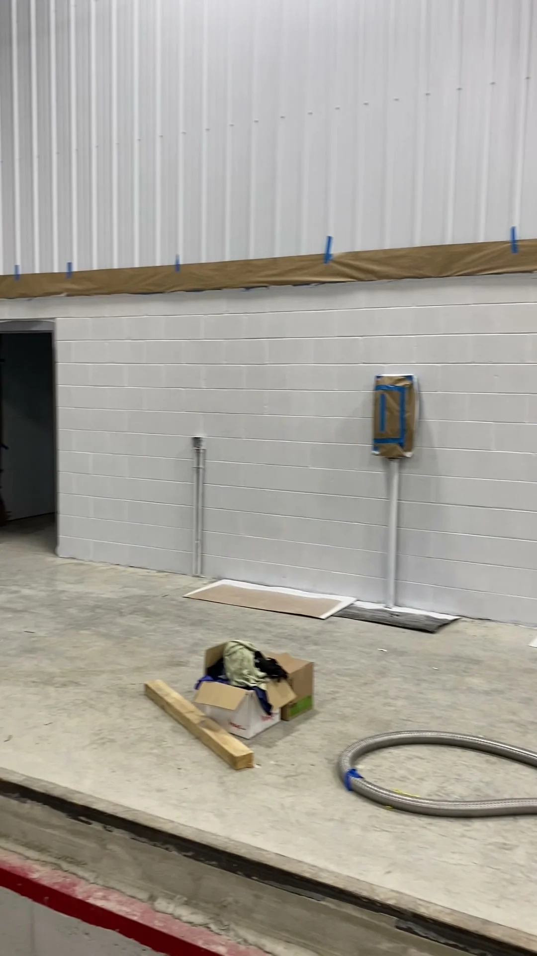 Completed block fill — another section of the new construction CMU wall, fully sealed and smooth