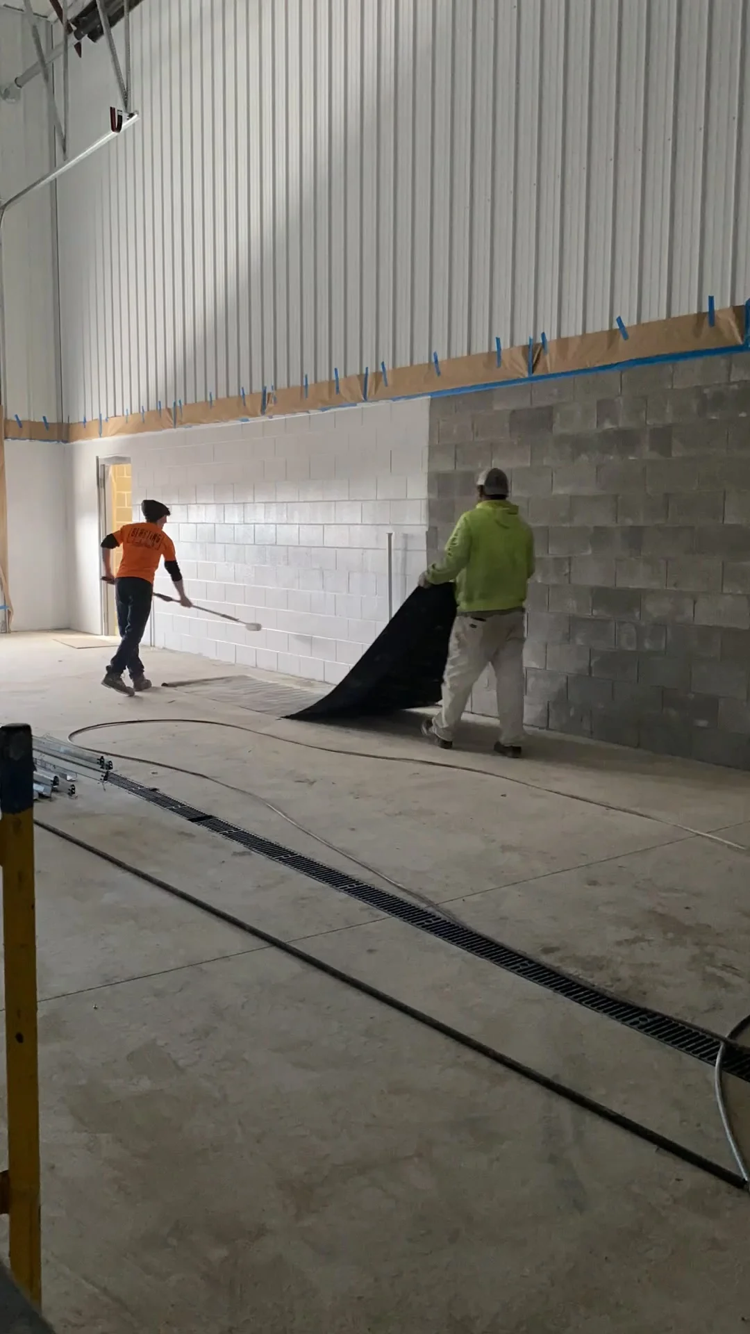 Crew laying floor protection before block fill application begins