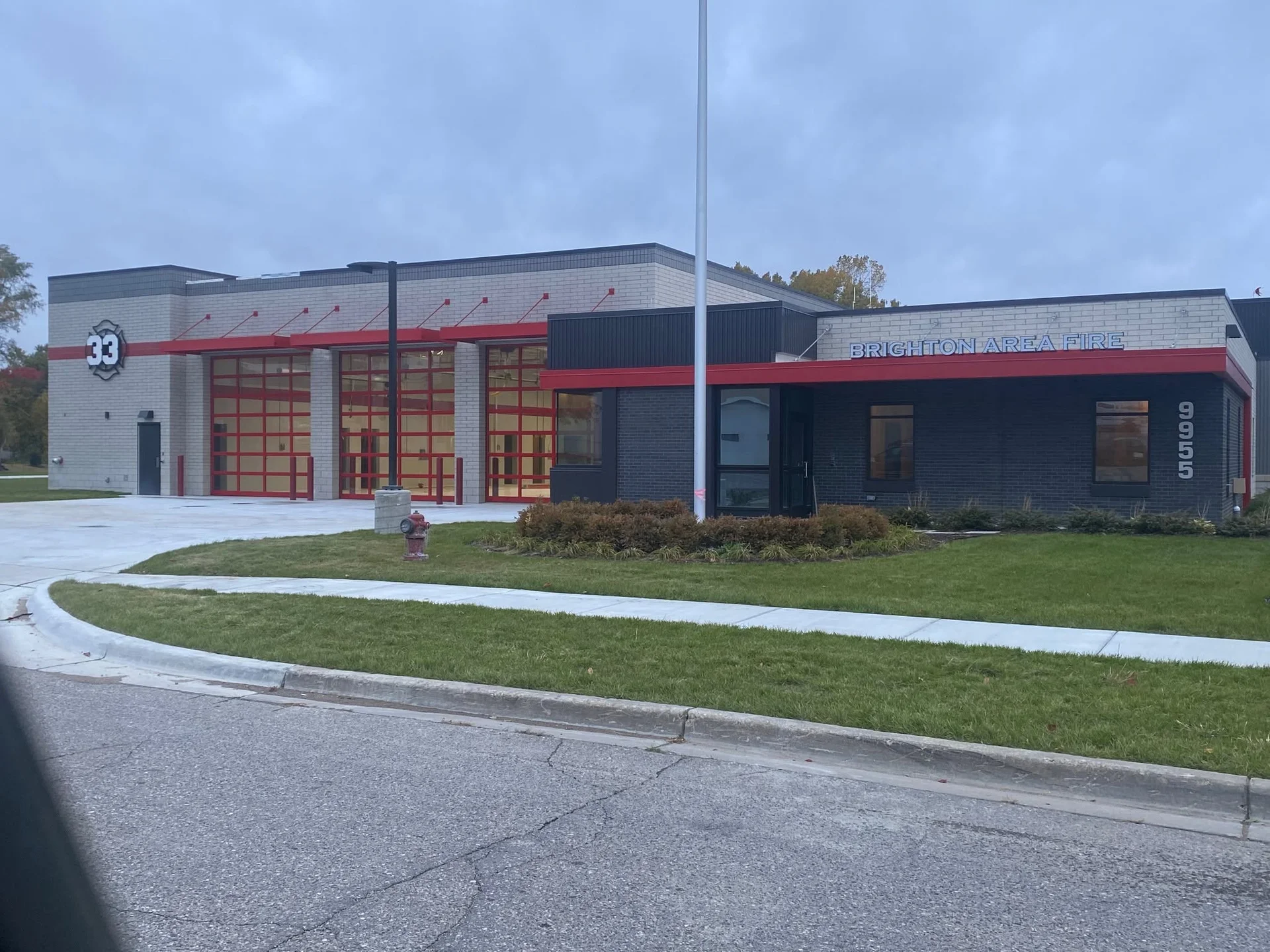 Brighton Area Fire Station 33 exterior, freshly painted with red and navy accent trim on new construction