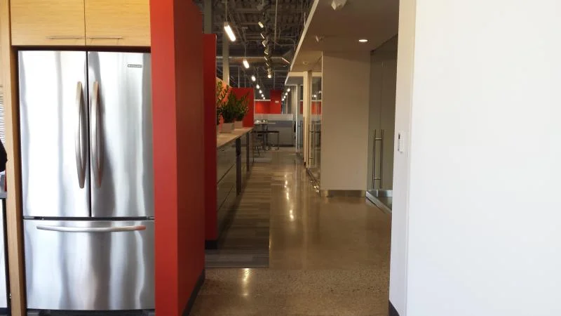 Office break room and kitchen area with red accent column and freshly painted walls