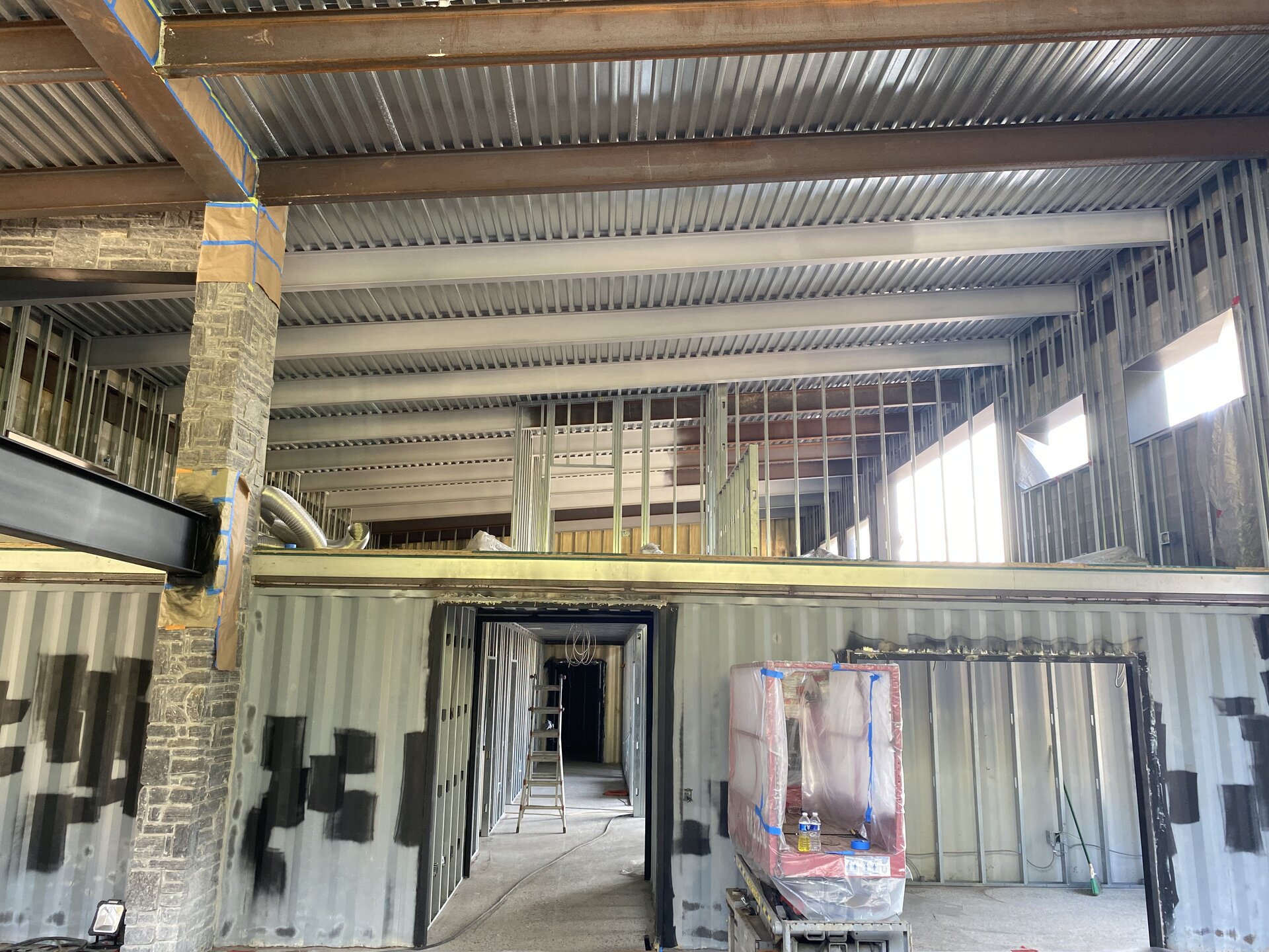 Interior view of container house structure during construction and painting