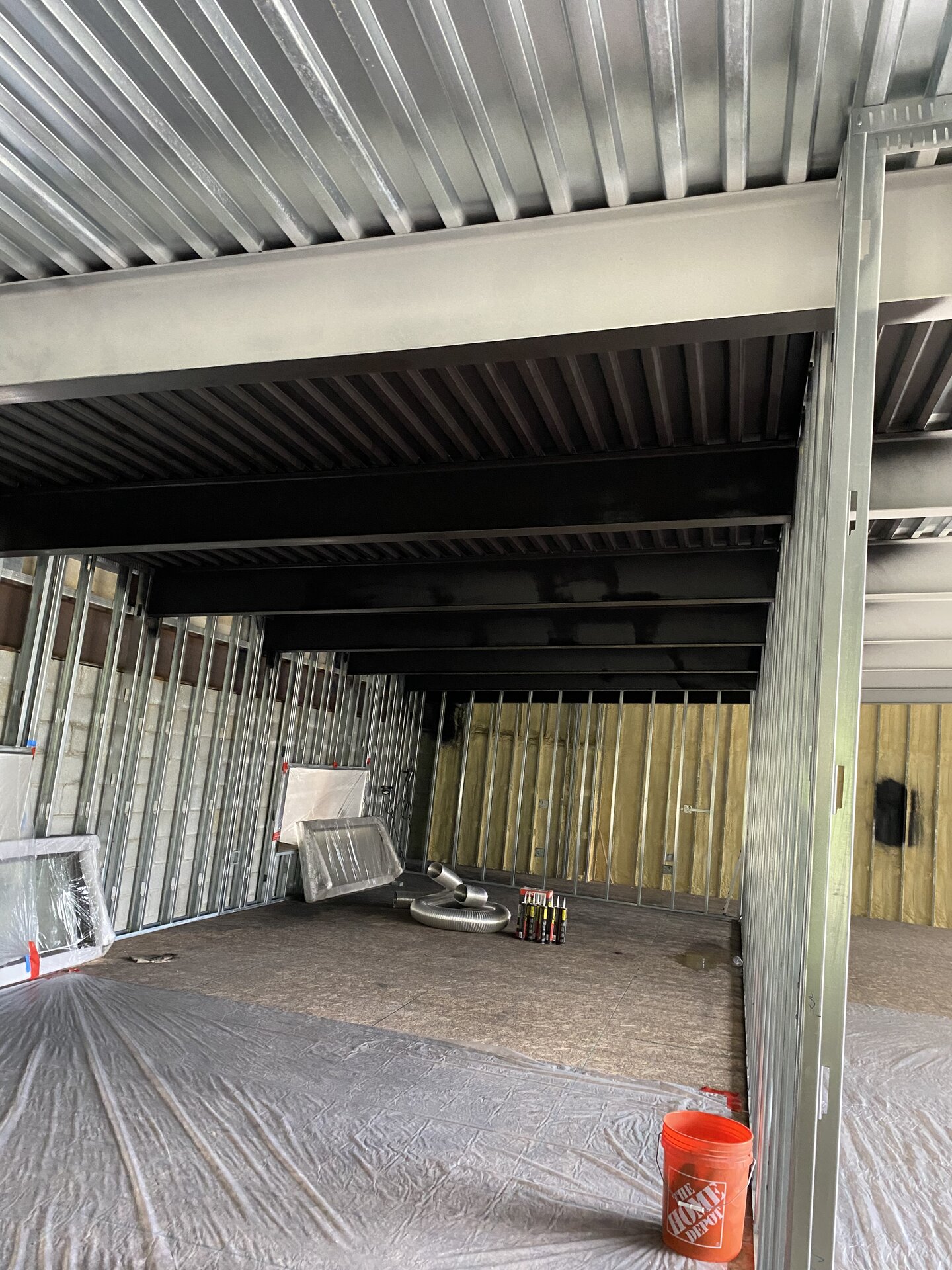 Dark painted steel ceiling and beams inside container house