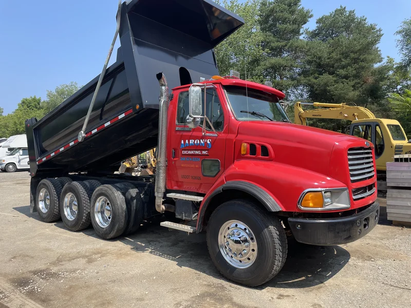 After — Aaron's Excavating Sterling tri-axle dump truck cab repainted in bright red