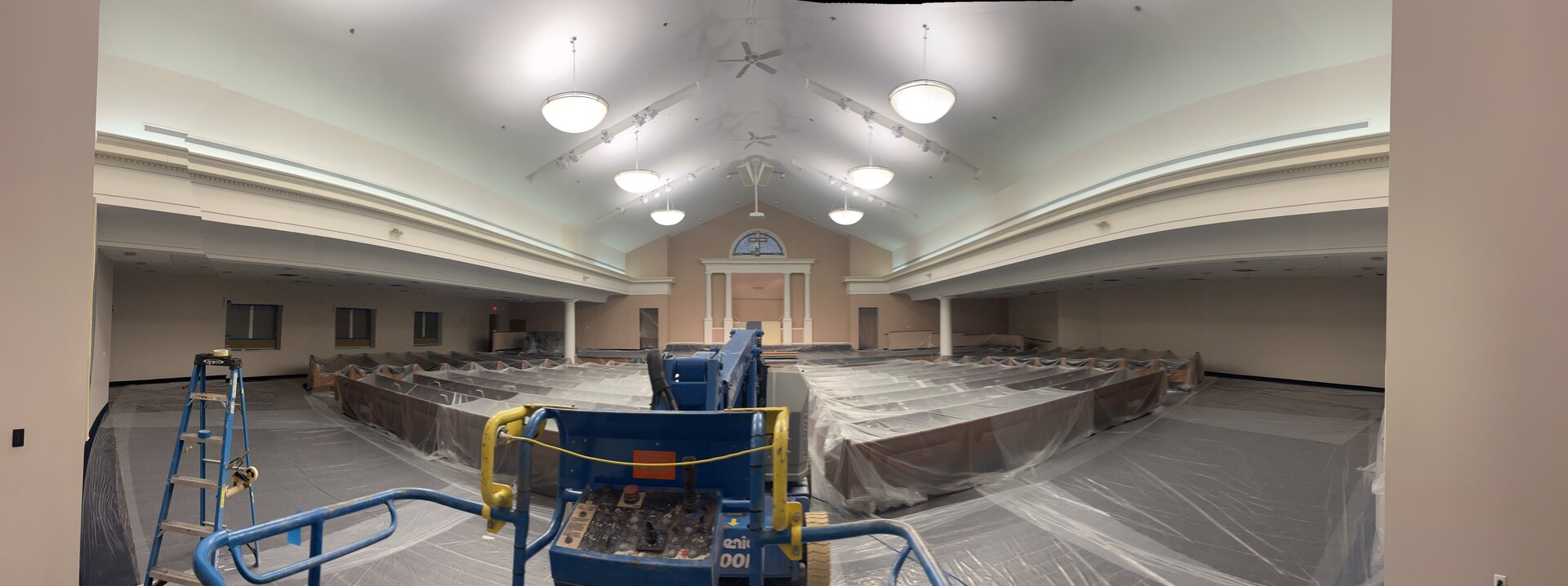 Auditorium repaint progress — wall surfaces during application