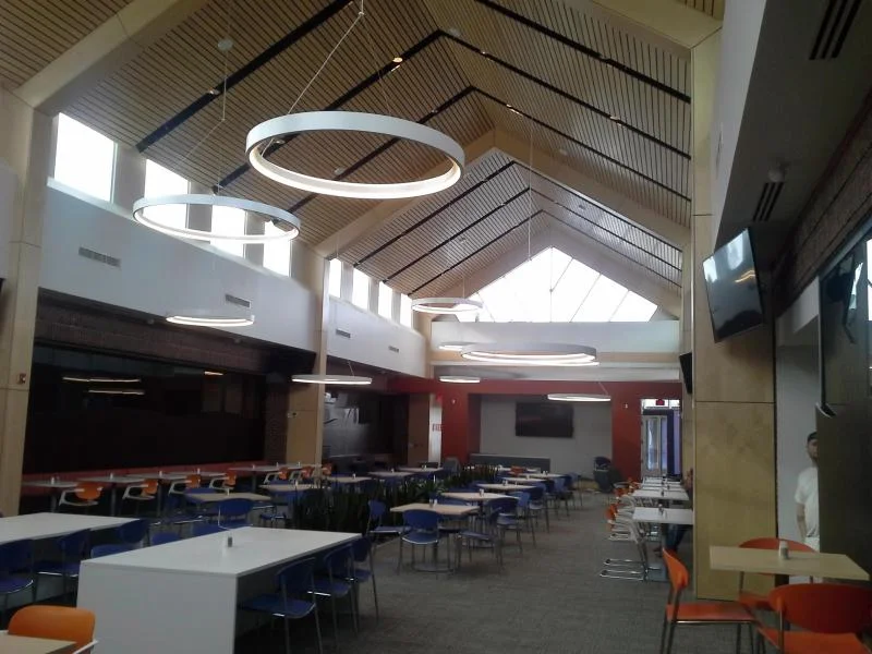 Gentherm office cafeteria with freshly painted red accent wall and vaulted ceiling