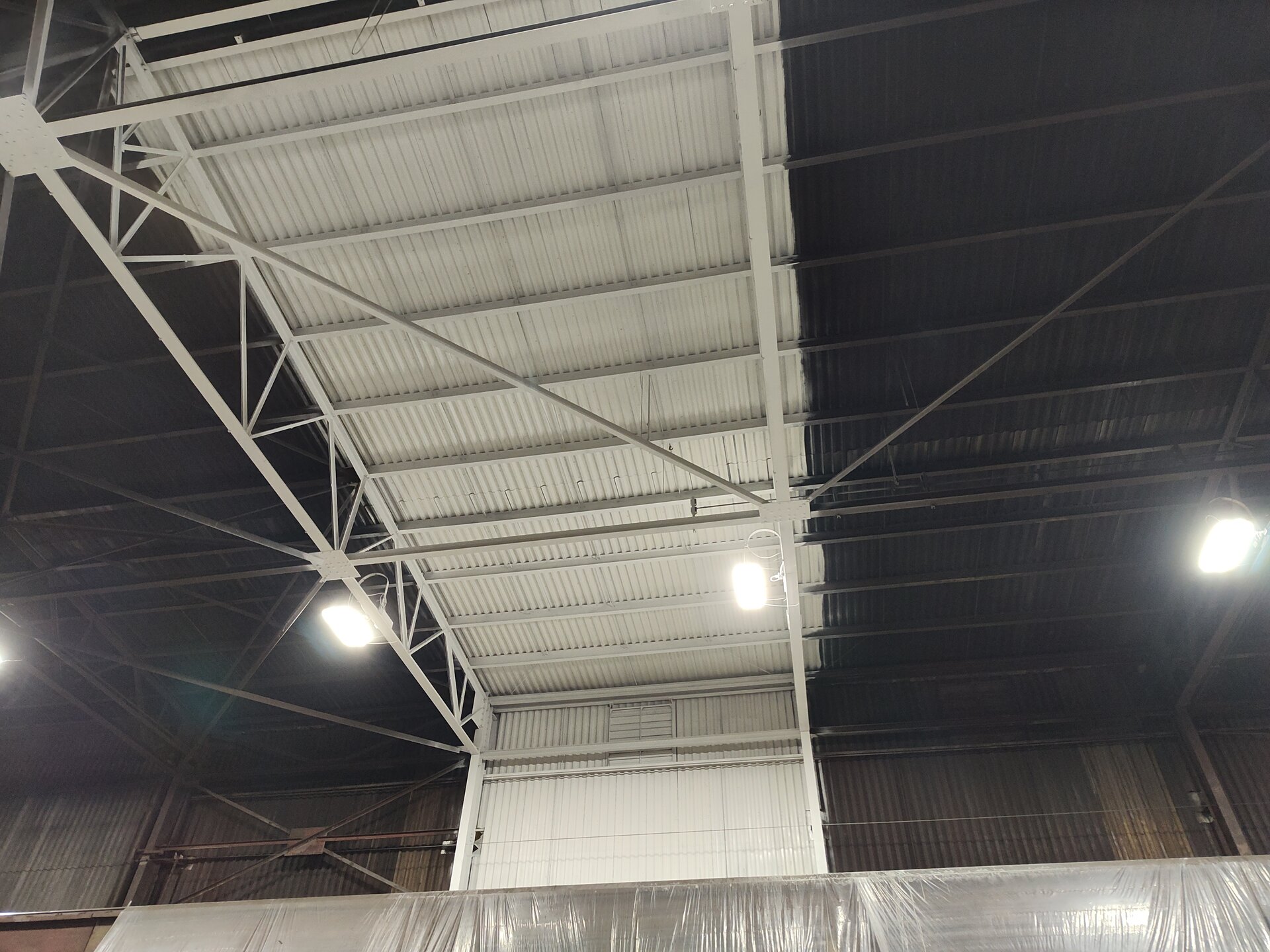 Paint sample detail — structural steel members coated white in working steel mill environment