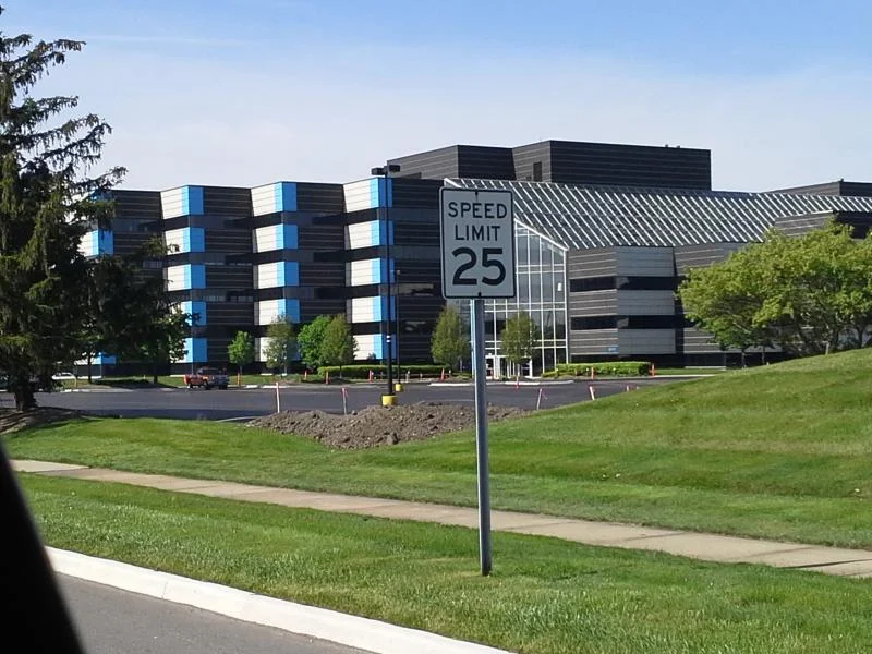 Wide view of the office building exterior from the road