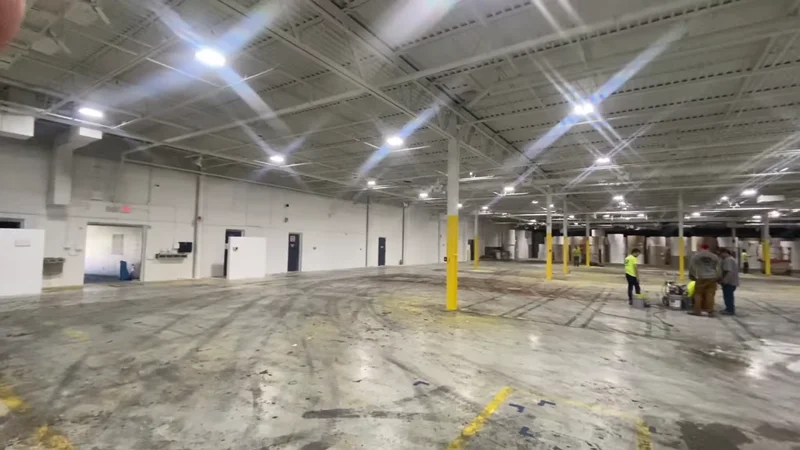 Endurance Painting crew prepping the floor across the open 150,000 sq. ft. LuxWall building