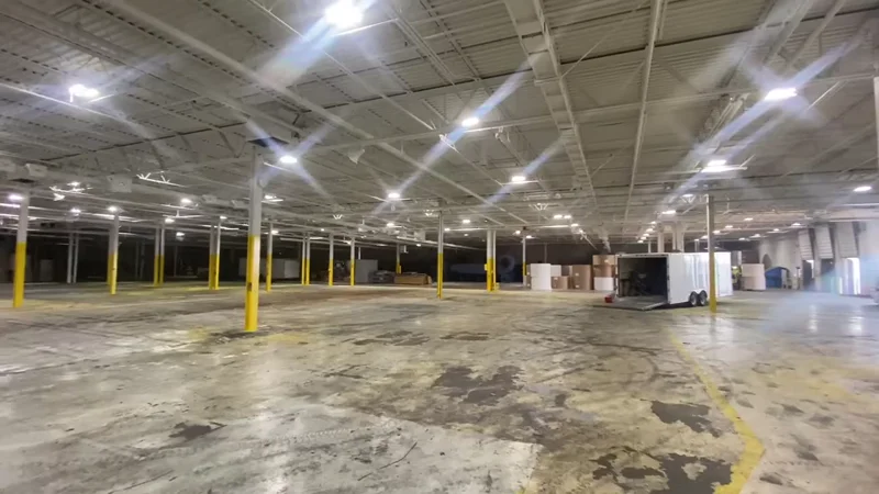 Full-length view of the LuxWall facility — painted deck ceiling, joists, and walls with yellow safety columns