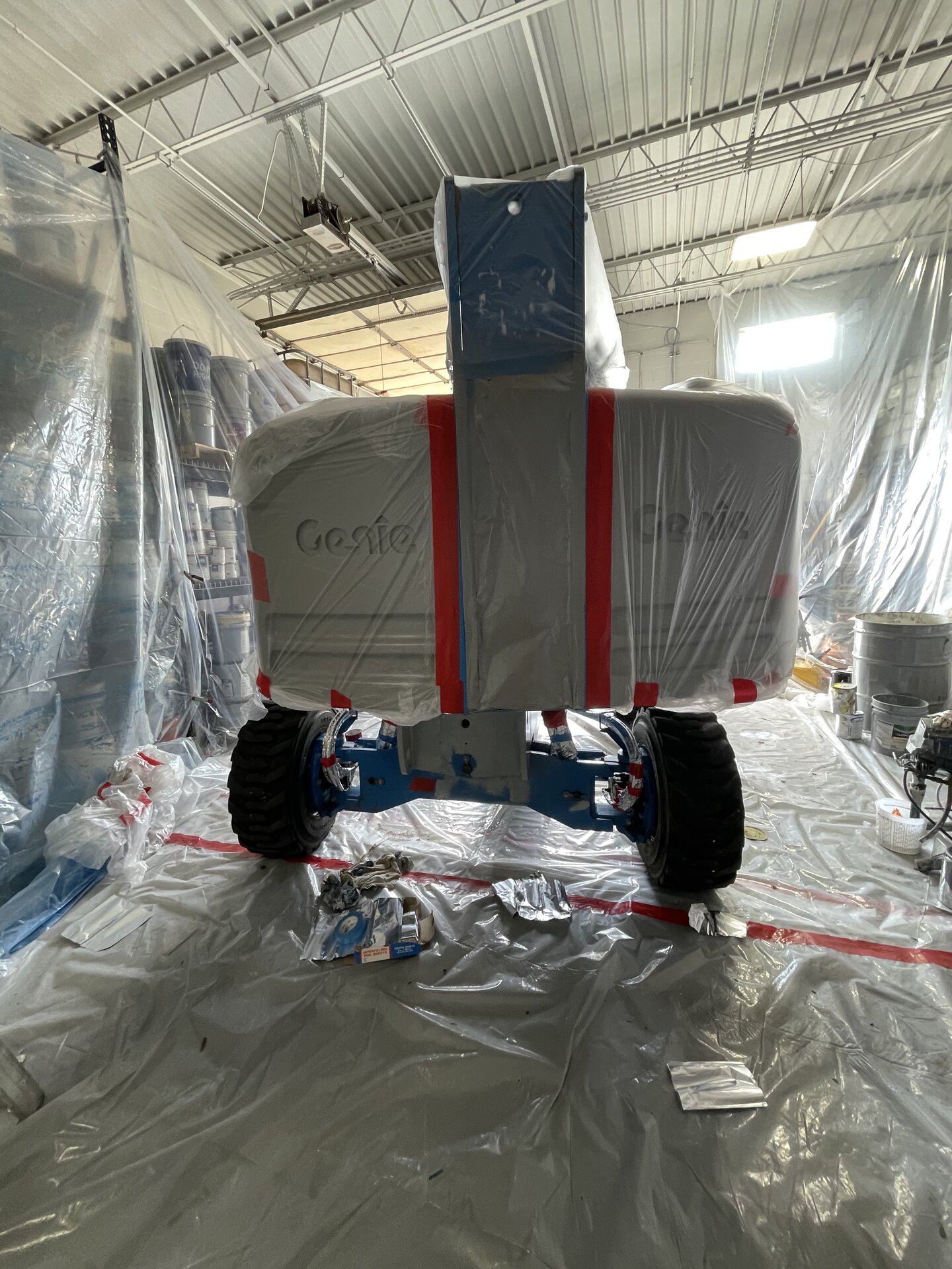 Lift boom arm repainted — clean coat from platform to base