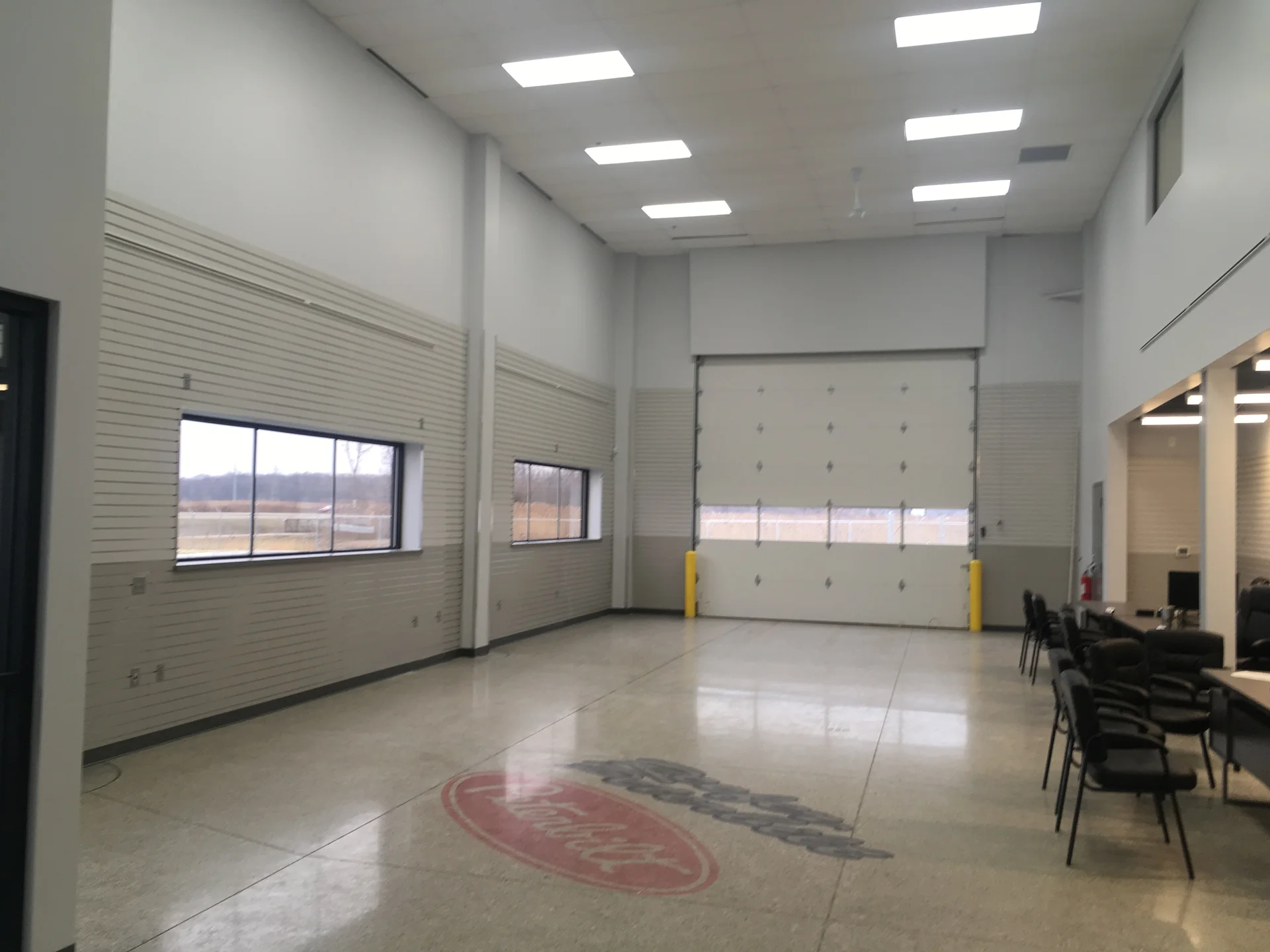 Peterbilt service bay interior with freshly painted walls and overhead door