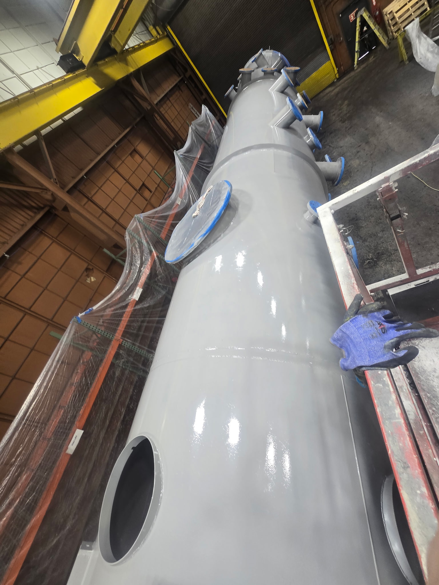 Low angle view along vessel showing high-gloss gray specialty coating finish