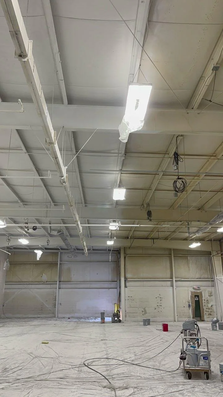 Superior Abrasives warehouse — freshly painted white ceiling and structural steel