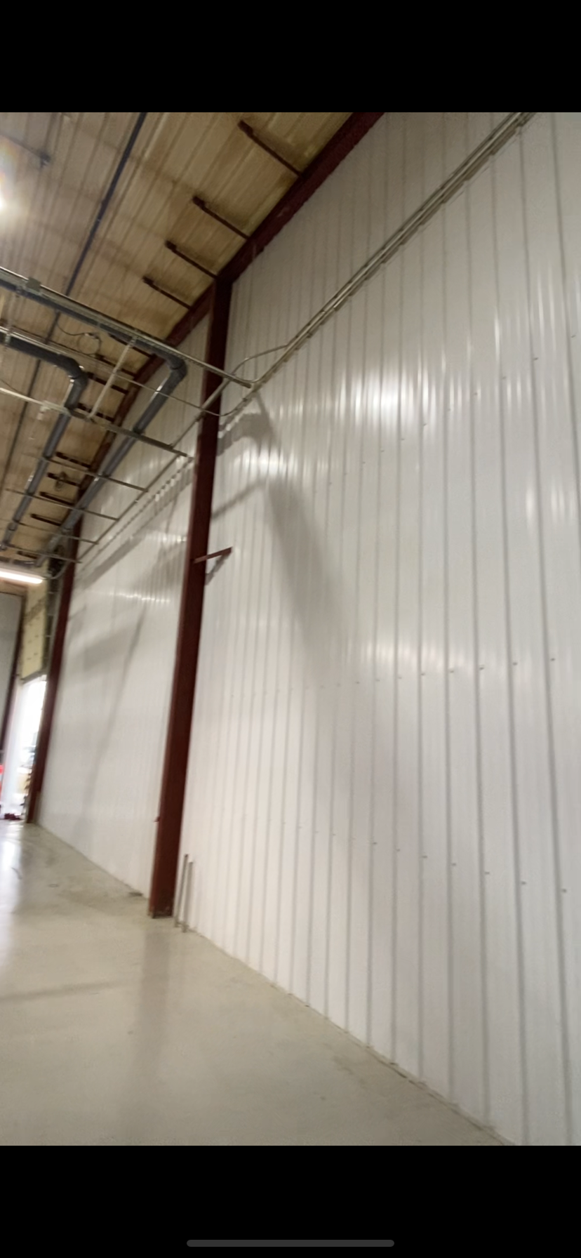 After — clean bright white finished wall at Vibracoustic