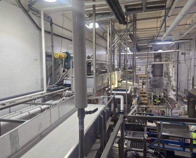 Full facility overview showing completed white wall coating