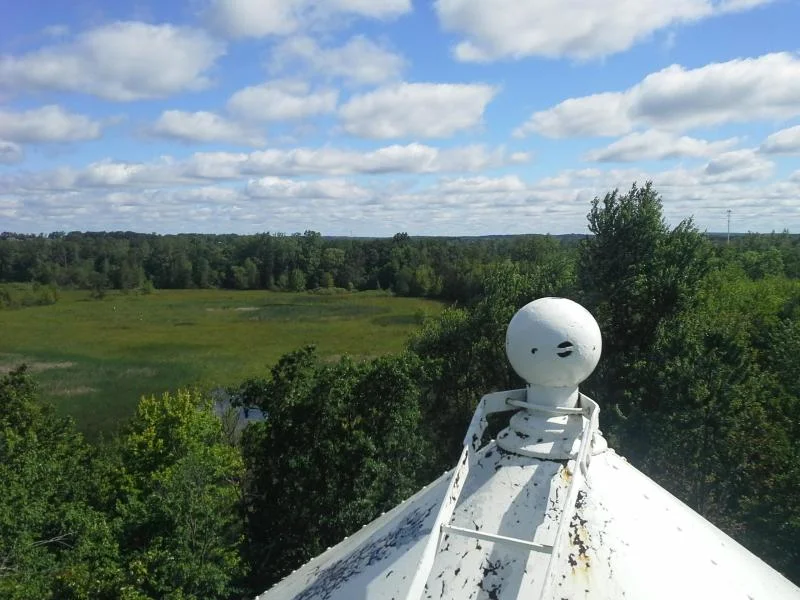 Freshly painted tower roof and tank, crisp white finish