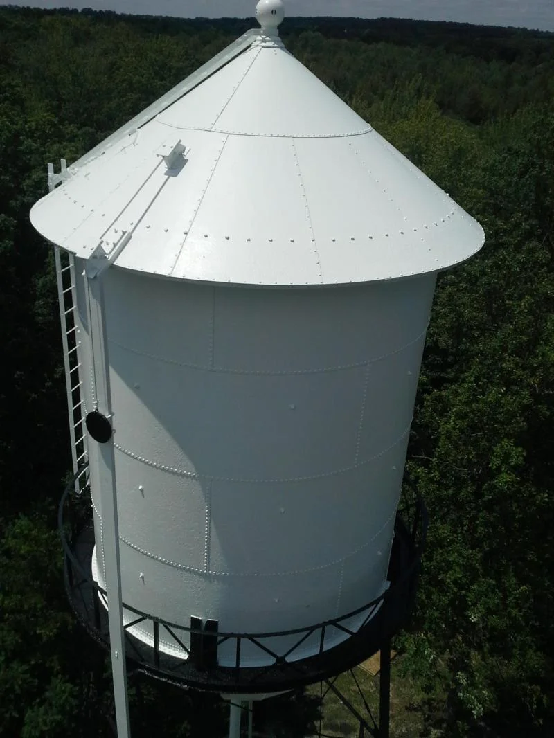 Wide view looking up at the completed water tower against the sky