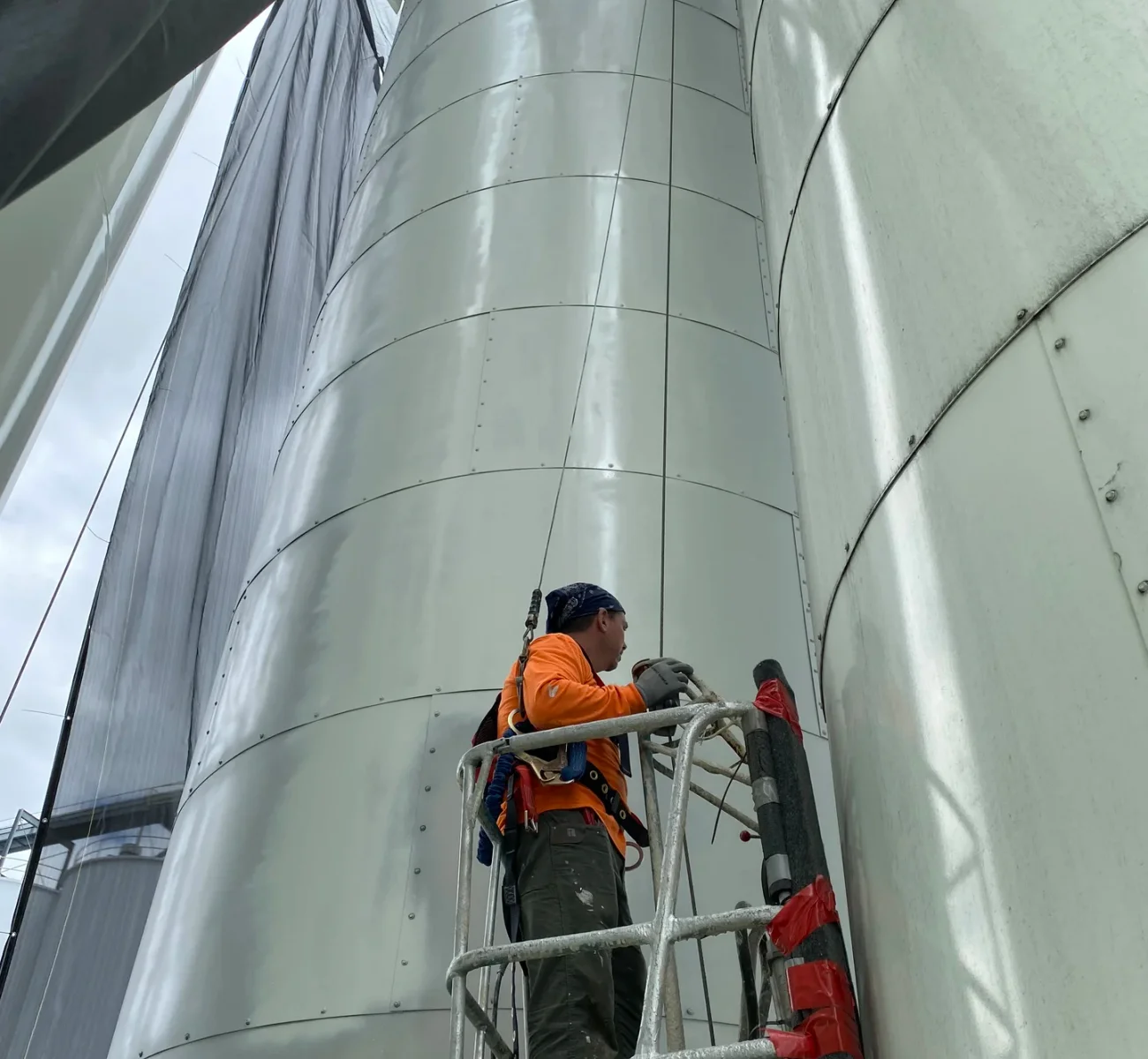 Jiffy tank farm industrial coating project — boom lift and containment